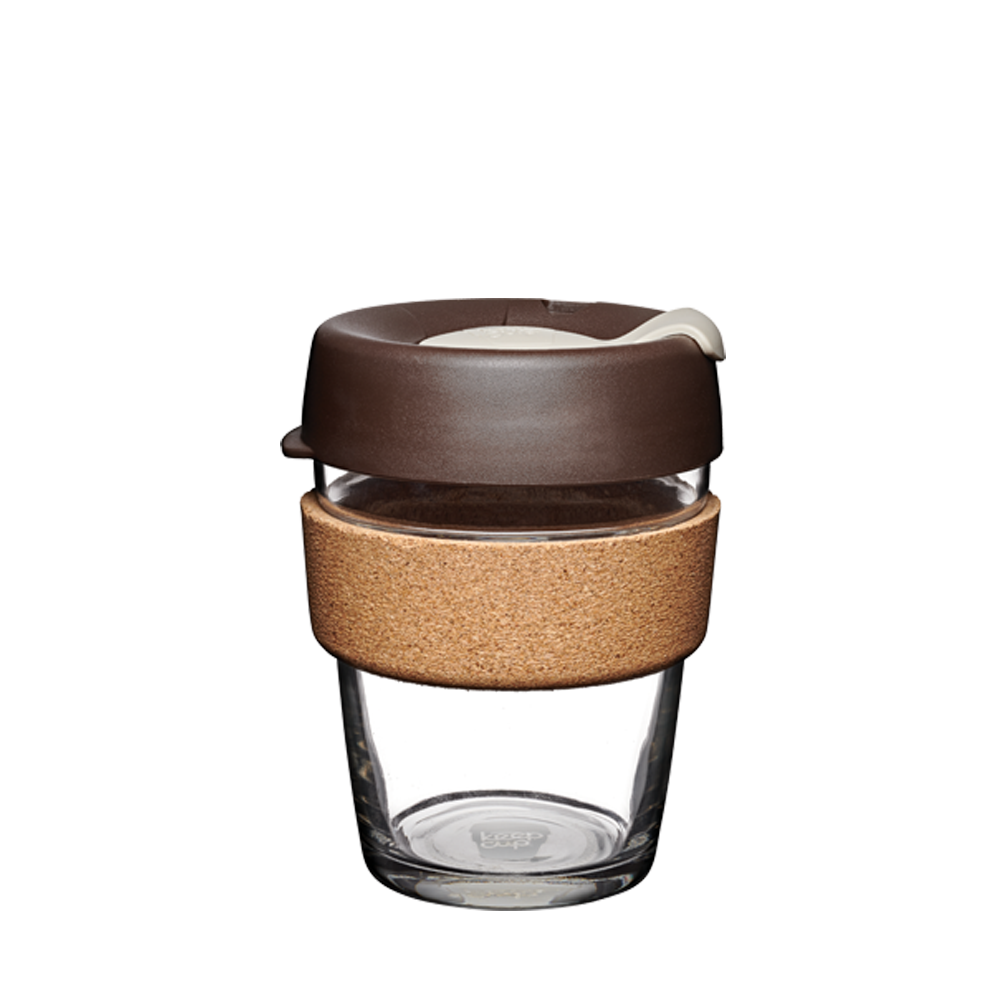 KeepCup Brew Cork M 12oz in Almond, featuring a clear tempered glass cup with natural cork band and brown plastic lid with cream-coloured plug, shown against a plain white background.