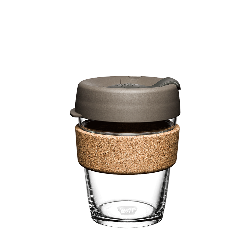 KeepCup Brew Cork M 12oz in Latte colour, featuring a clear tempered glass cup with natural cork band and warm grey silicone lid, shown against a white background.