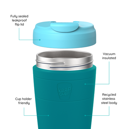 A teal and light blue KeepCup travel tumbler with callout labels explaining features like the leakproof flip lid, vacuum insulation, recycled stainless steel body, and cup holder friendliness.