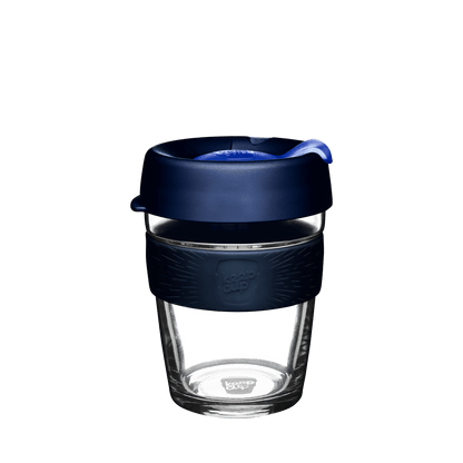 KeepCup Brew M 12oz in Ink colour, featuring a clear glass cup with a navy blue silicone band and dark blue lid with a blue plug, shown against a white background.