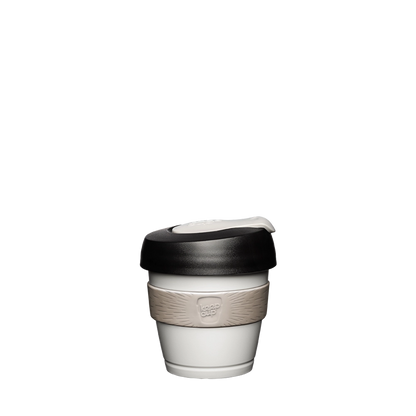 KeepCup Original XXS 4oz in Arctic colour, featuring a white cup body with beige silicone band and black lid with cream-coloured plug, shown against a plain white background.