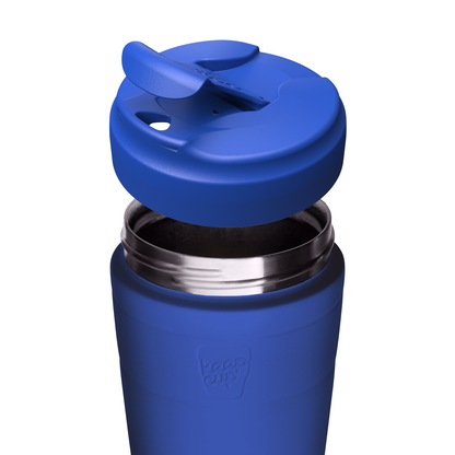 A close-up of a blue insulated KeepCup travel tumbler with its lid removed, showing the stainless steel rim and interior, on a white background.