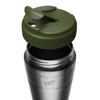 An pine green silicone lid with a flip-up straw cover, shown attached to a stainless steel KeepCup travel mug. The tumbler features a brushed silver finish with a silver shield logo embossed on the front.