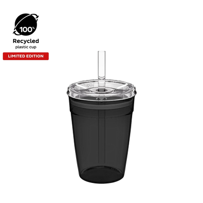 Cold Cup Original M 12oz in Recycled Black, shown from a front angle against a white background, featuring a translucent black cup body, clear lid with straw hole, and clear reusable straw. Limited edition badge and 100% recycled plastic cup icon displayed in top left corner.