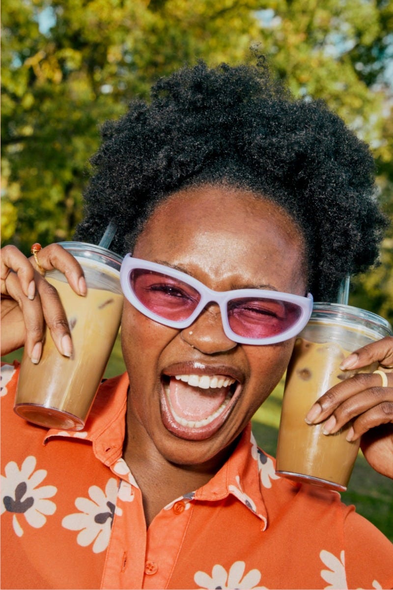 Woman holding KeepCup Sip & Chill Original Clear reusable cup with coffee and iced tea