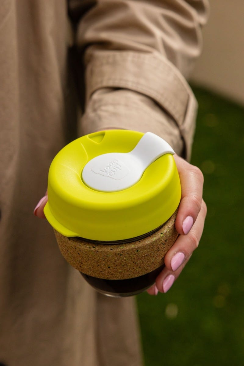 Woman holding KeepCup Brew Cork Ace 8oz with coffee