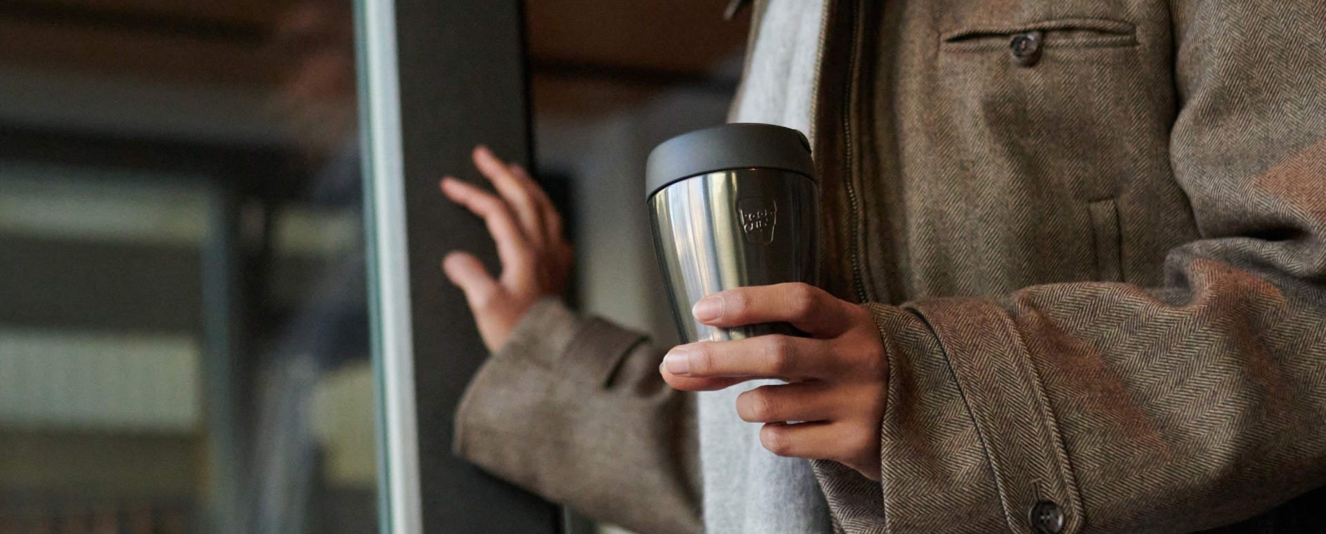 Woman holding KeepCup Traveller 8oz with coffee