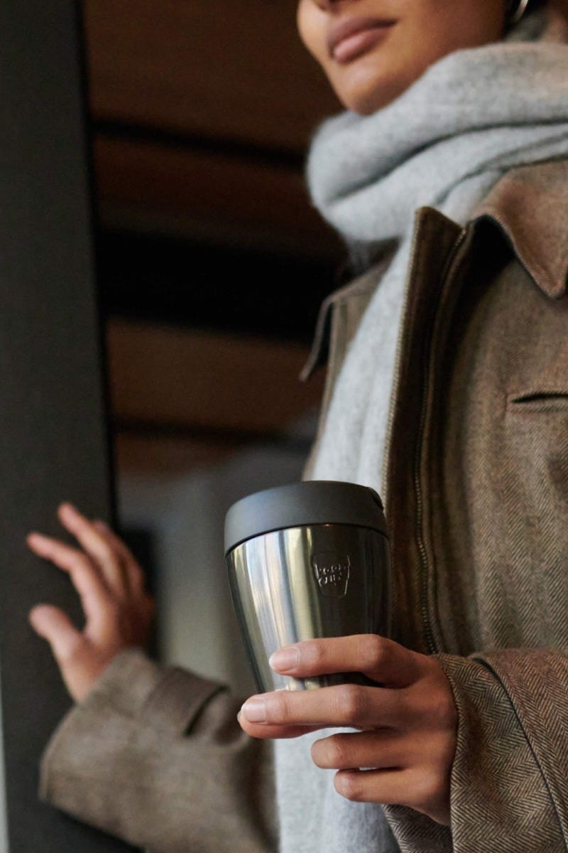 Woman holding KeepCup Traveller 8oz with coffee
