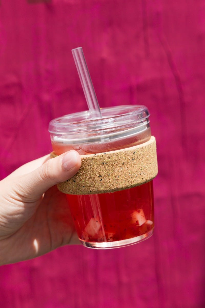 Woman holding KeepCup Sip & Chill Brew Cork reusable glass cup